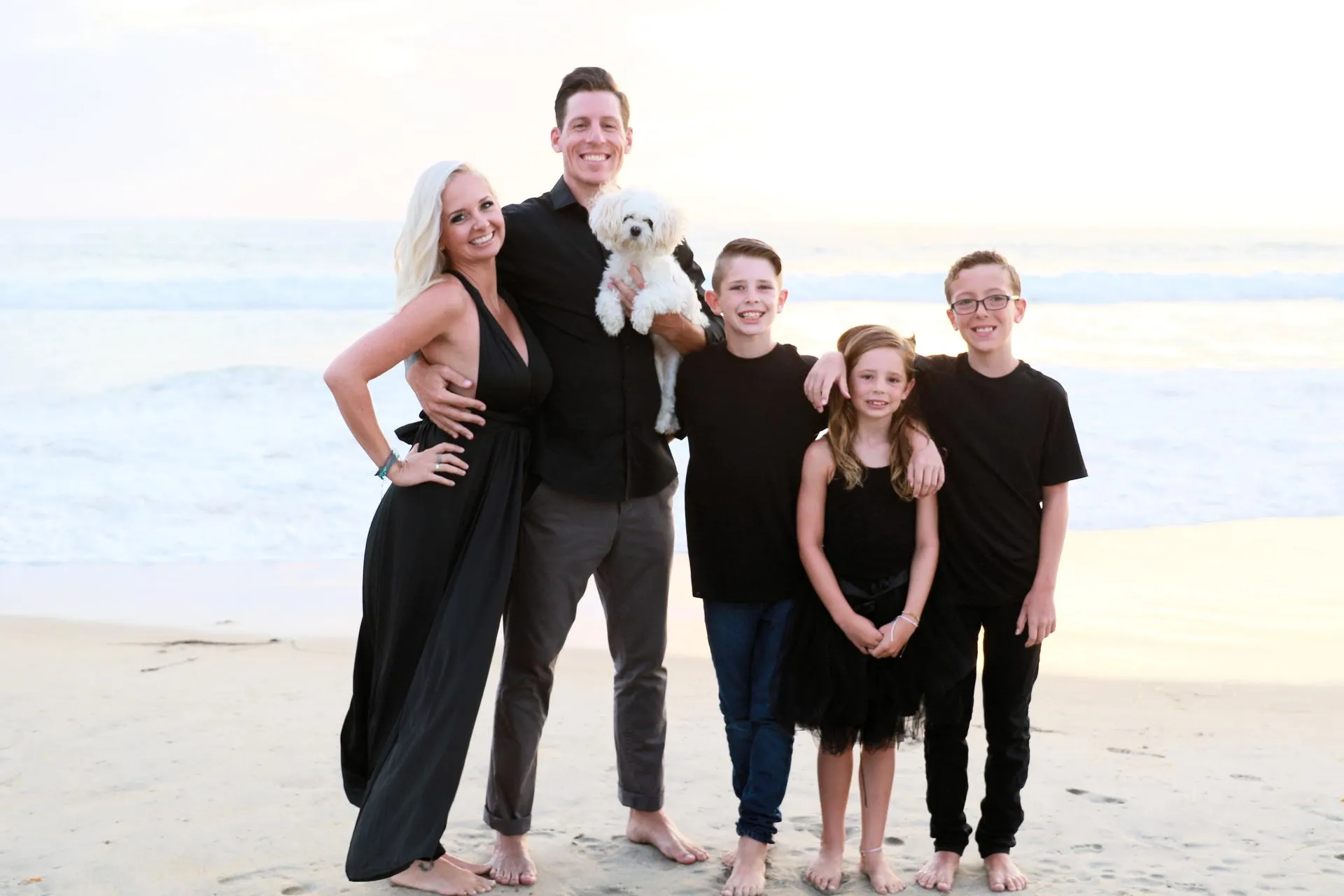 Ashlee Heying and family standing on the beach